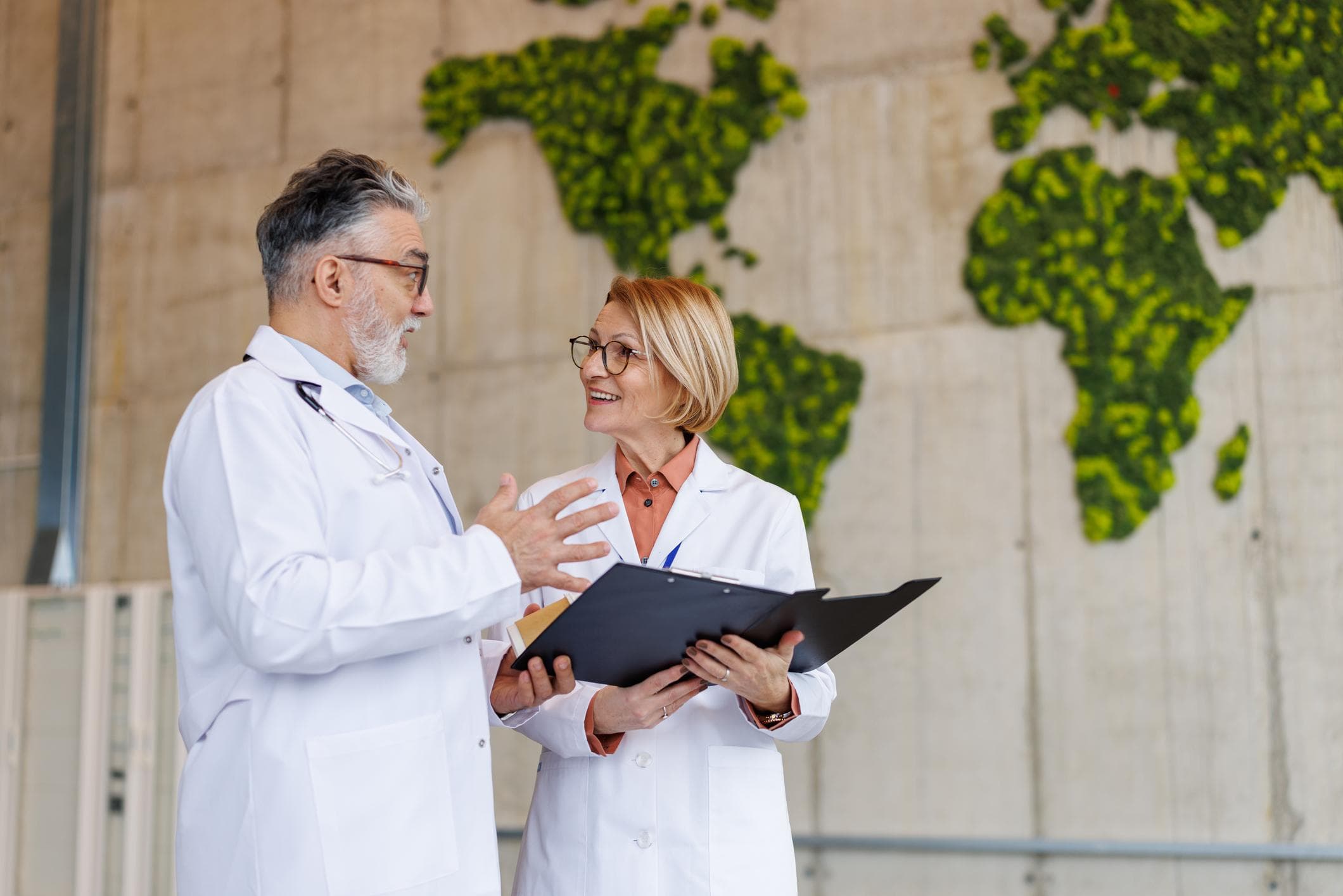 Senior medical faculty in consultation within a clinical teaching environment.